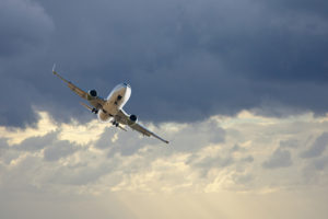White Jet in Cloudy Sky