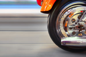 Back wheel of an orange motorcycle