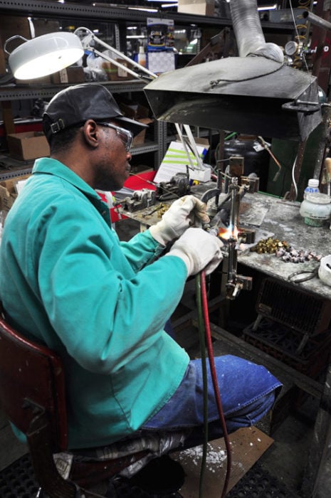 Man brazing at workbench